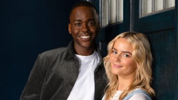 The 15th Doctor and Ruby Sunday stand leaning against the front door on the Tardis.