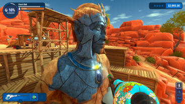The player character sprays water on a giant statue of a man, cleaning rust off of it