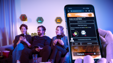 Three friends sit next to each other with a phone close-up showing a prompt about whether or not to keep citizens inside