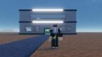 Roblox Breaking Bad Tycoon Avatar Wearing Silver Helmet Standing Outside Grey Building And Black Road