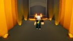 Roblox Super Eleven Avatar Wearing Silver Helmet And Massive Left Arm Standing In Black Floored Hallway With Orange Lights