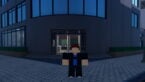 Roblox Fistborn A Roblox Character With A Blue Shirt Black Jacket And Brown Hair Stands In Front Of A Modern Grey Building At Night