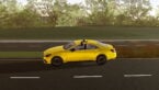 Roblox Corsa Legends Avatar Driving A Golden Yellow Sports Car Down The Black Road With Bushes On Opposite Side